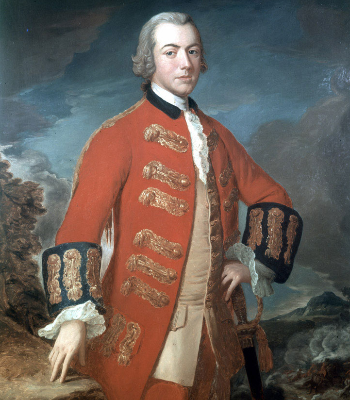 Clinton stands in a classical pose with his hand on his hip, wearing his red army coat that is decorated in gold braid